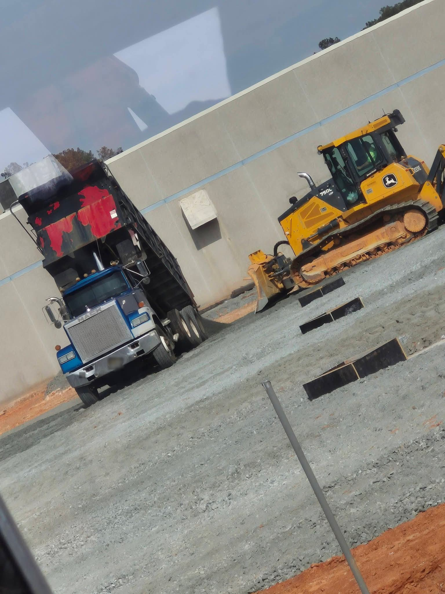 Material delivery by dump truck